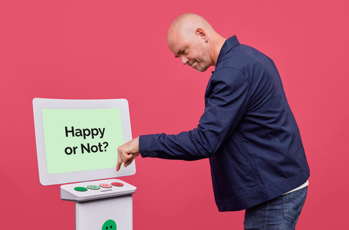 Man pressing a smiley button