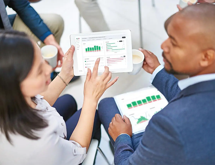 Integrations_seamless integrations analytics block image 2 people looking at integrated data analytics on tablet