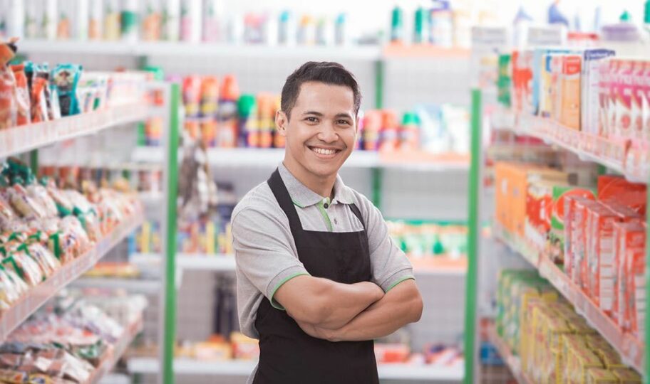 Convenience store worker in location serving customers