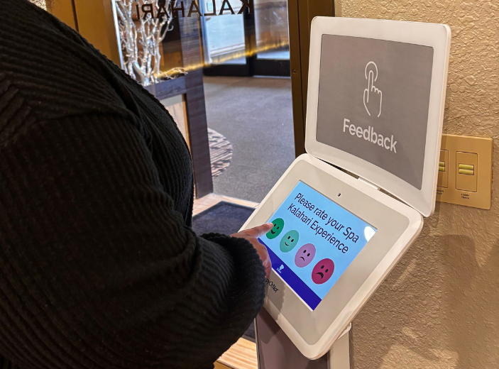 Guest rating their Spa Kalahari experience using a HappyOrNot Smiley Touch feedback device